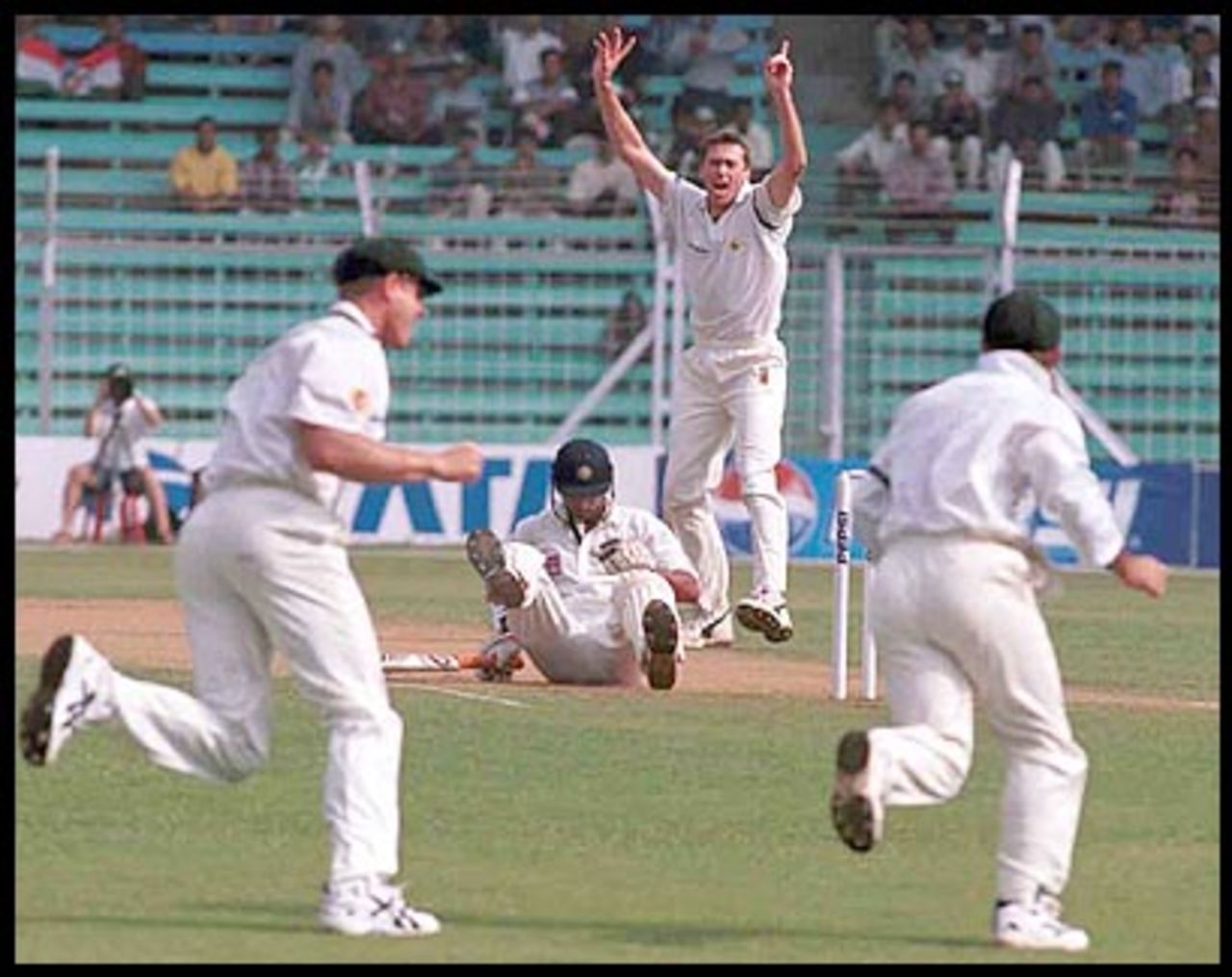 McGrath and the close cordon cheer Ramesh's fall. Australia in India 2000/01, 1st Test, India v Australia, Wankhede Stadium, Mumbai 27Feb-03Mar 2001 (Day 1)