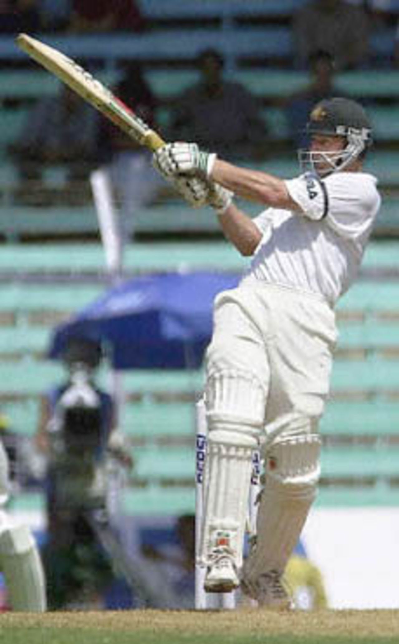 Australian batsman Adam Gilchrist pulls a delivery to the fence on way to scoring an unbeaten 103 on the second day of the first test match between India and Australia at Wankhade stadium in Bombay 28 February 2001. Gilchrist and team-mate Mathew Hayden hit centuries to put Australia in strong position at 266 for 5 after lunch in reply to India's 176 runs.