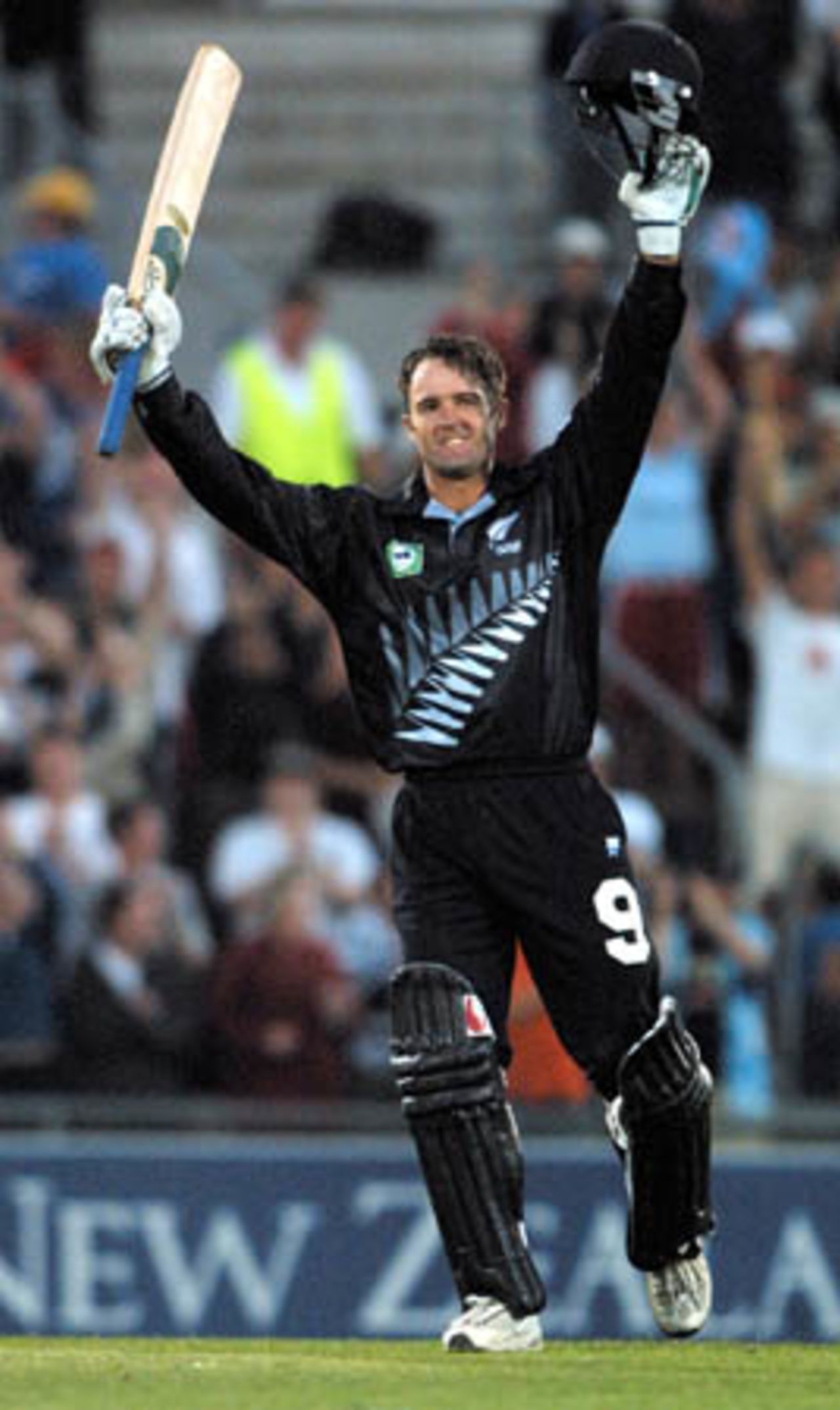 New Zealand opening batsman Nathan Astle raises his bat to the crowd in celebration of reaching his ninth One-Day International century off 93 balls. Man of the Match Astle went on to score 119. 5th One-Day International: New Zealand v Pakistan, Carisbrook, Dunedin, 28 February 2001.