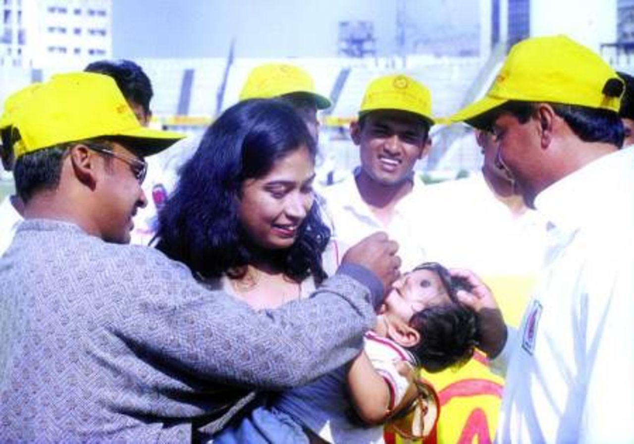 Naimur Rahman and Minhajul Abedin, current and former skippers of Bangladesh giving polio vaccine to the children at the Bangabandhu National Stadium on the National Polio Polio Vaccination Day on December 17, 2000