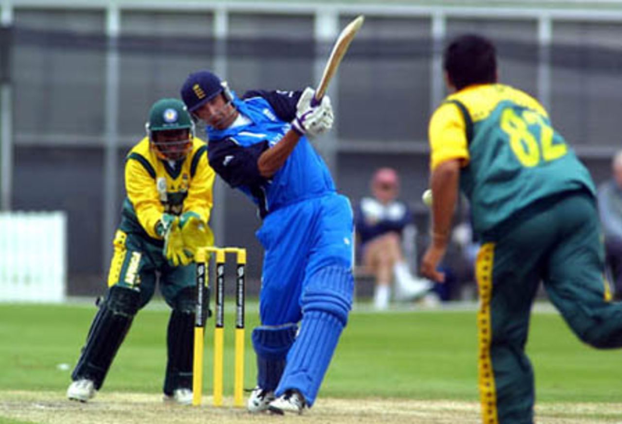 England Under-19 batsman Kadeer Ali drives a delivery down the ground on the leg side during his innings of 44. Wicket-keeper Zwelibanzi Homani looks on. ICC Under-19 World Cup Super League Group 2: England Under-19s v South Africa Under-19s at Lincoln Green, Lincoln, 1 February 2002.