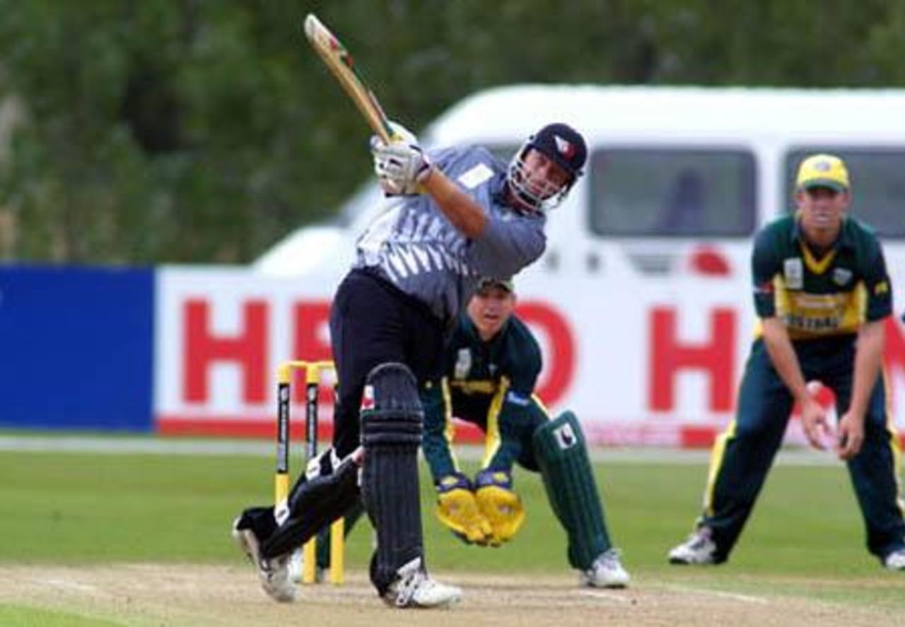 New Zealand Under-19 batsman Jesse Ryder hits a delivery over long on during his innings of 70. Wicket-keeper Adam Crosthwaite looks on. ICC Under-19 World Cup Super League Group 2: Australia Under-19s v New Zealand Under-19s at Bert Sutcliffe Oval, Lincoln, 1 February 2002.