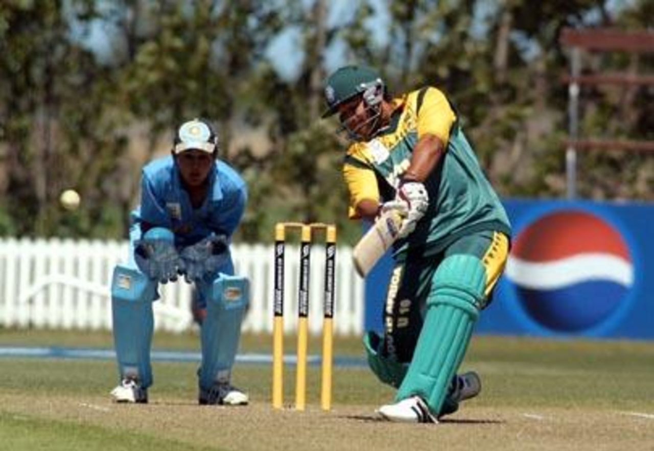 South Africa Under-19 batsman Ryan Bailey drives a delivery from India Under-19 bowler Rakesh Mohanty through the covers during his innings of nine. Wicket-keeper Parthiv Patel looks on. 1st ICC Under-19 World Cup Super League Semi Final: India Under-19s v South Africa Under-19s at Bert Sutcliffe Oval, Lincoln, 3 February 2002.