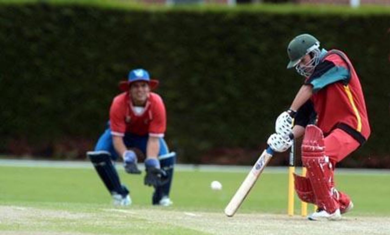 Zimbabwe Under-19 batsman Charles Coventry square drives a delivery during his innings of five. Namibia Under-19 wicket-keeper Hugo Ludik looks on. 1st ICC Under-19 World Cup Plate Championship Semi Final: Namibia Under-19s v Zimbabwe Under-19s at Lincoln No. 3, Lincoln, 4 February 2002.