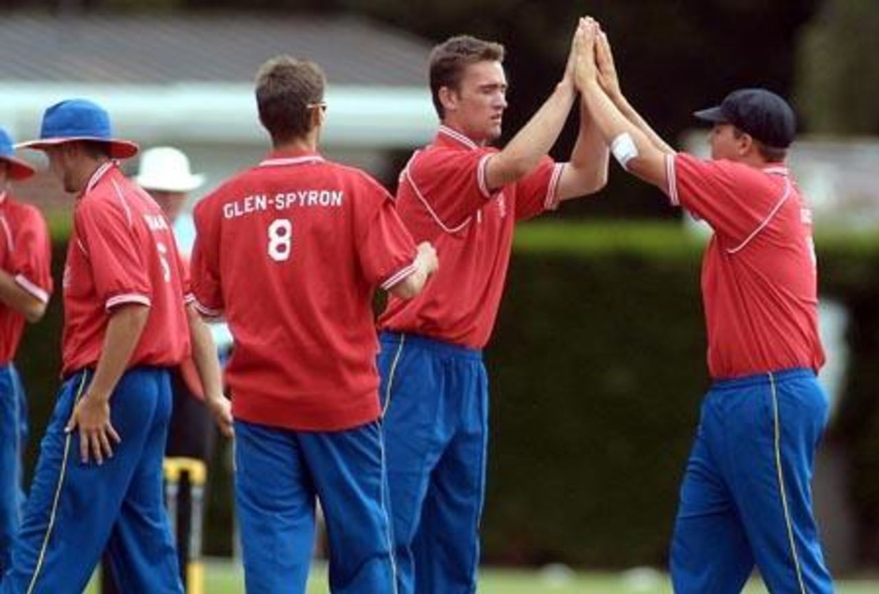 Namibia Under-19 bowler Hendrik Geldenhuys (second from right) high-fives with Colin Steytler to celebrate the dismissal of Zimbabwe Under-19 batsman Charles Coventry, bowled for five. 1st ICC Under-19 World Cup Plate Championship Semi Final: Namibia Under-19s v Zimbabwe Under-19s at Lincoln No. 3, Lincoln, 4 February 2002.