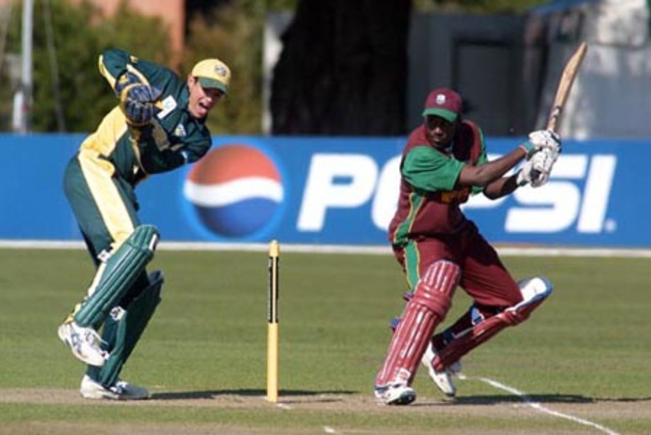 West Indies Under-19 batsman Tonito Willett plays a late cut to the boundary during his innings of 83. Australia Under-19 wicket-keeper Adam Crosthwaite looks on. 2nd ICC Under-19 World Cup Super League Semi Final: Australia Under-19s v West Indies Under-19s at Bert Sutcliffe Oval, Lincoln, 6-7 February 2002 (7 February 2002).