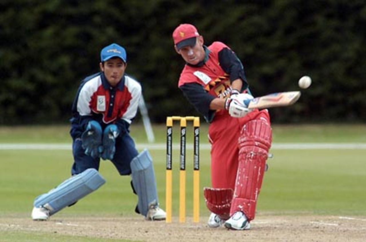 Zimbabwe Under-19 batsman Charles Coventry hits a delivery down the ground during his innings of 64. Nepal Under-19 wicket-keeper Manoj Katuwal looks on. ICC Under-19 World Cup Plate Championship Final: Nepal Under-19s v Zimbabwe Under-19s at Lincoln No. 3, Lincoln, 8 February 2002.
