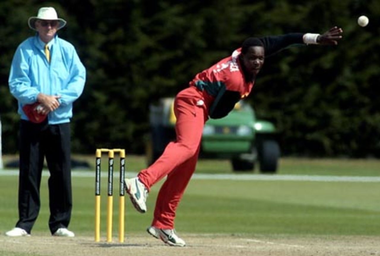 Zimbabwe Under-19 bowler Hamilton Masakadza delivers a ball during his spell of 3-16 from 5.4 overs. Umpire Tony Cooper from Fiji looks on. ICC Under-19 World Cup Plate Championship Final: Nepal Under-19s v Zimbabwe Under-19s at Lincoln No. 3, Lincoln, 8 February 2002.