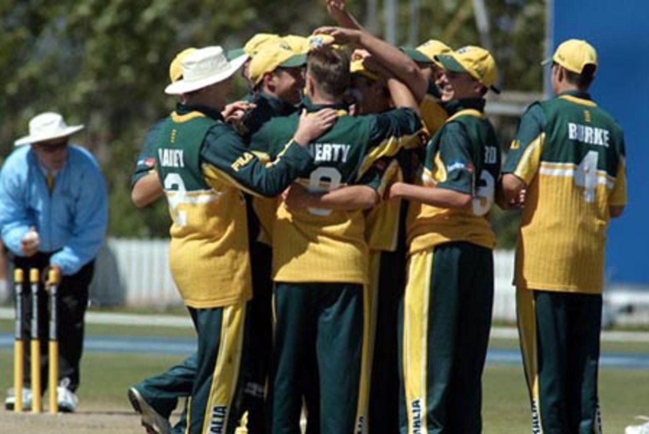 Australia Under-19 players celebrate the dismissal of South Africa Under-19 batsman Ryan Bailey, run out for two. Umpire Tony Hill fixes the stumps in the background. ICC Under-19 World Cup Super League Final: Australia Under-19s v South Africa Under-19s at Bert Sutcliffe Oval, Lincoln, 9 February 2002.