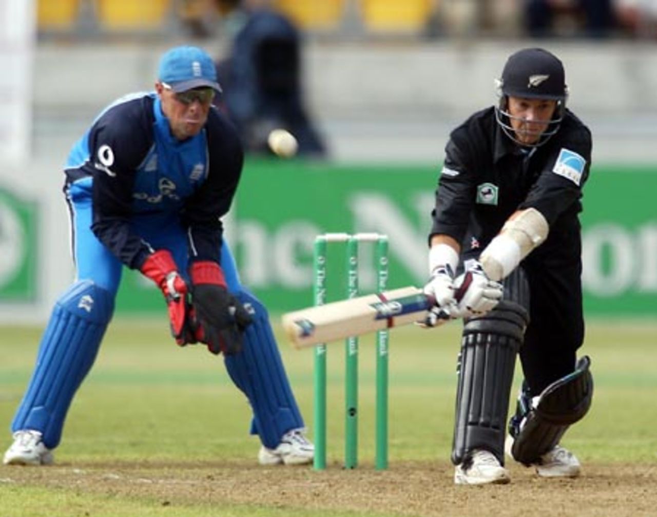 New Zealand batsman Craig McMillan plays a reverse sweep during his innings of 69. England wicket-keeper Marcus Trescothick looks on. 2nd ODI: New Zealand v England at WestpacTrust Stadium, Wellington, 16 February 2002.