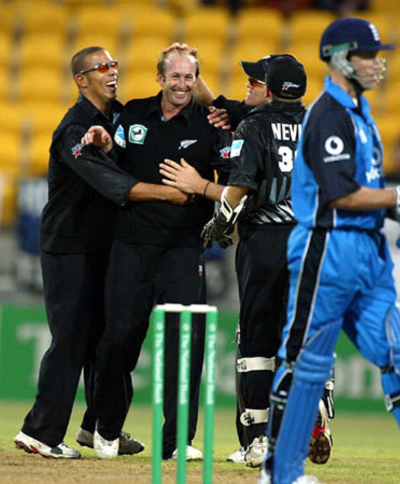 New Zealand bowler Chris Harris (second from left) is congratulated by team-mates after dismissing England batsman Craig White, lbw for 11. From left, Andre Adams, Lou Vincent (obscured) and Chris Nevin. 2nd ODI: New Zealand v England at WestpacTrust Stadium, Wellington, 16 February 2002.