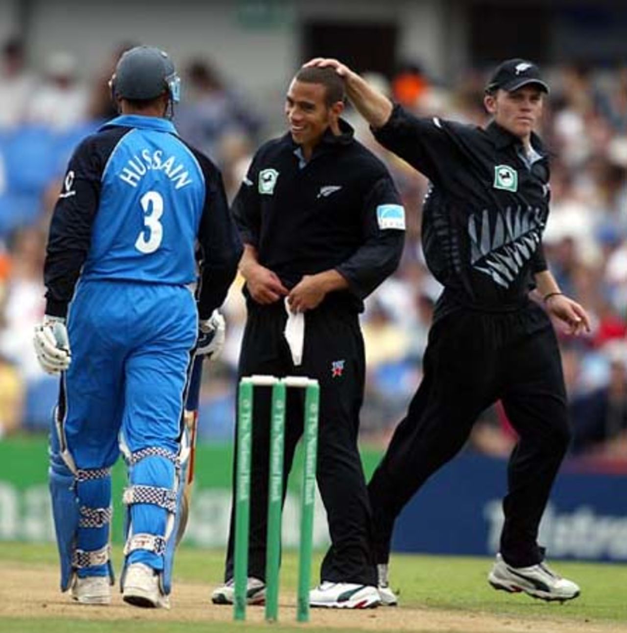 New Zealand bowler Andre Adams is patted on the head by team-mate Lou Vincent as he has a few words with England batsman Nasser Hussain at the end of an over during his spell of 0-36 from eight overs. 4th ODI: New Zealand v England at Eden Park, Auckland, 23 February 2002.
