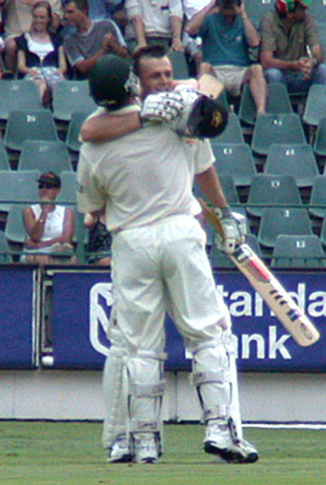 Adam Gilchrist celebrates his century with Damien Martyn