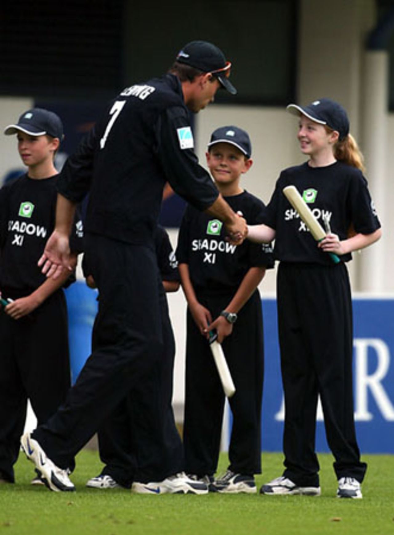 New Zealand captain Stephen Fleming shakes hands with members of the Shadow XI as his team walks on to the field. The Shadow XI receive a signed bat from a designated CLEAR Black Cap player before returning to free seats in the crowd. 3rd ODI: New Zealand v England at McLean Park, Napier, 20 February 2002.