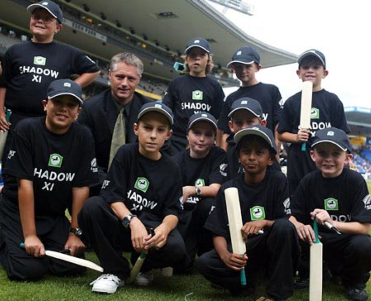 National Bank sponsorship manager Gavin Larsen with members of the Shadow XI. The Shadow XI receive a signed bat from a designated CLEAR Black Cap player before returning to free seats in the crowd. 4th ODI: New Zealand v England at Eden Park, Auckland, 23 February 2002.
