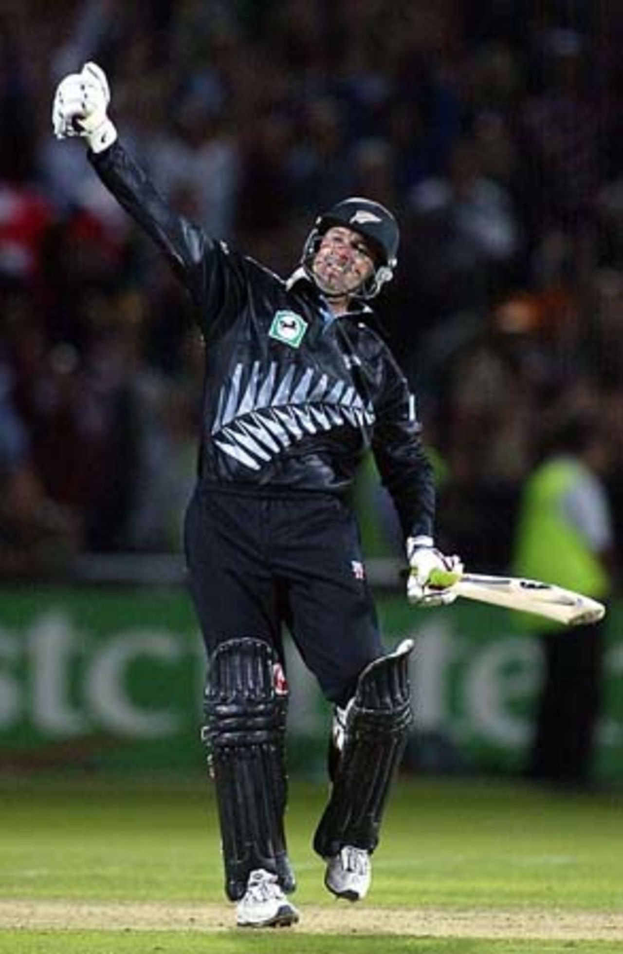New Zealand batsman Nathan Astle punches the air to celebrate reaching his century. Astle went on to score 122 not out. 5th ODI: New Zealand v England at Carisbrook, Dunedin, 26 February 2002.