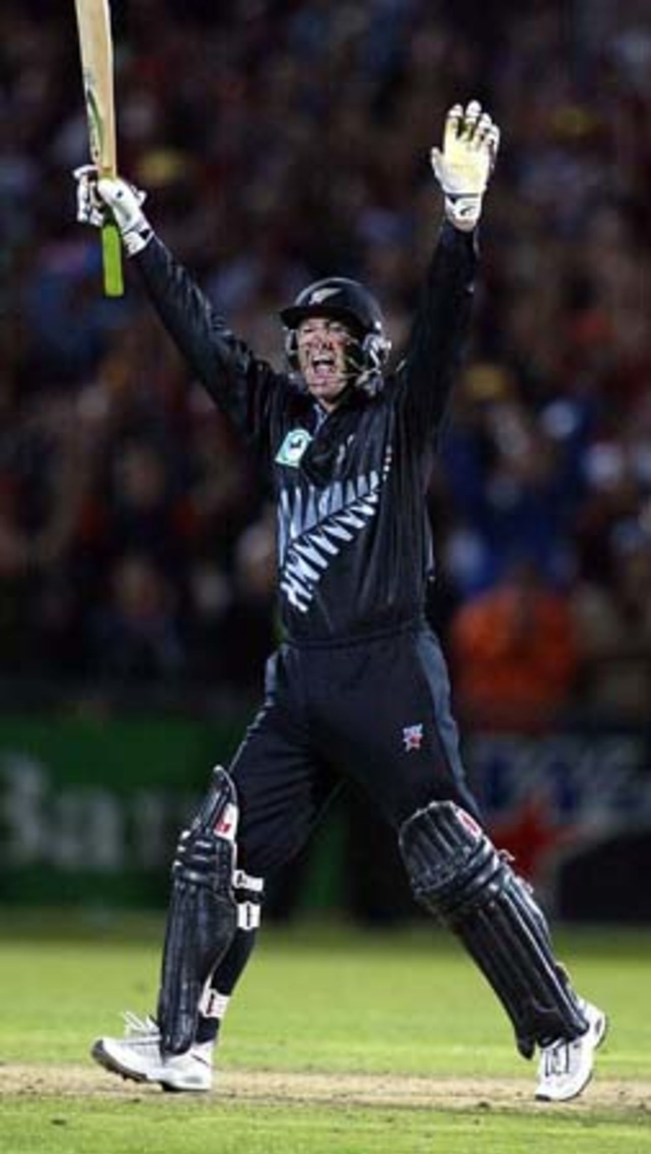 New Zealand batsman Nathan Astle celebrates hitting the winning runs, a six from the bowling of England bowler Andrew Flintoff to win the match by five wickets and the five match series 3-2. Astle scored 122 not out. 5th ODI: New Zealand v England at Carisbrook, Dunedin, 26 February 2002.