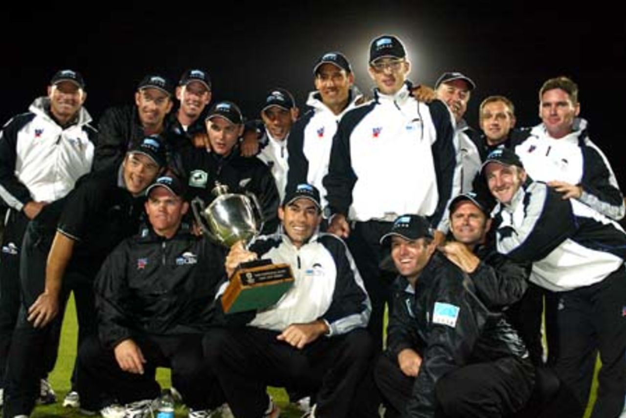 The New Zealand team pose with the National Bank Series trophy after beating England by five wickets to win the series 3-2. Back, from left, manager Jeff Crowe, Chris Harris, Ian Butler, Brendon McCullum, Andre Adams, Daryl Tuffey, Daniel Vettori, coach Denis Aberhart, physiotherapist Dayle Shackel and video analyst Zach Hitchcock. Front, from left, Craig McMillan, Lou Vincent, captain Stephen Fleming (with trophy), Nathan Astle, Chris Cairns and Chris Nevin. 5th ODI: New Zealand v England at Carisbrook, Dunedin, 26 February 2002.