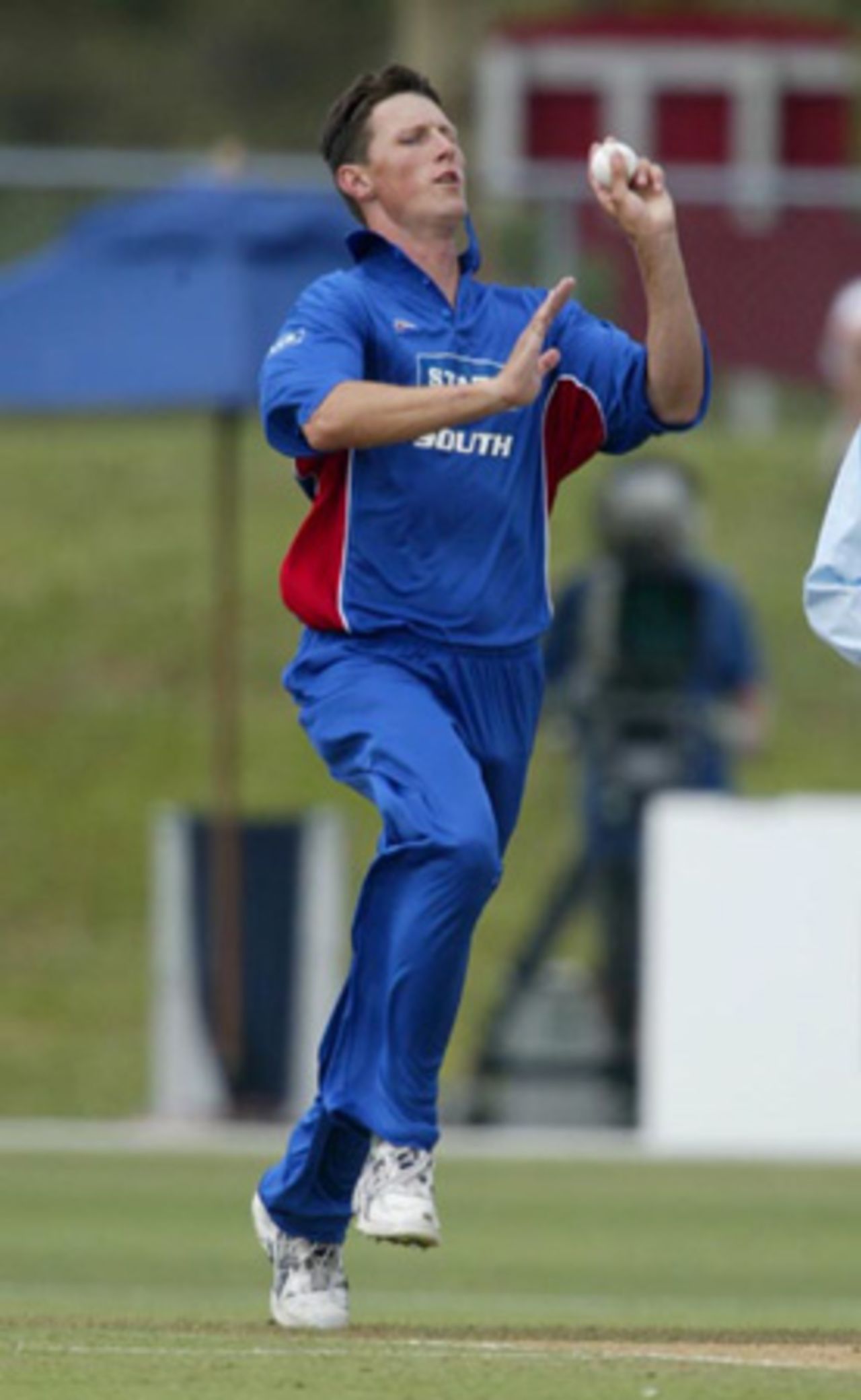South Island bowler Shayne O'Connor delivers a ball during his first innings spell of 0-35 from four overs. State of Origin: North Island v South Island at North Harbour Stadium, Auckland, 2 February 2003.