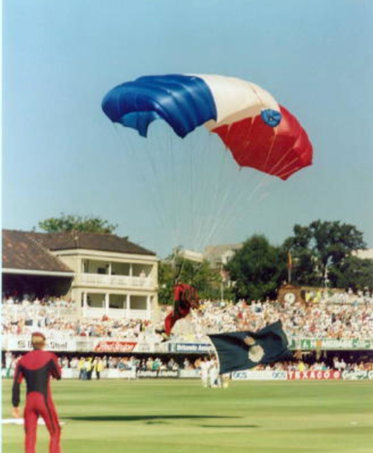 Parachutist delivers the Hampshire flag before the start of the match.