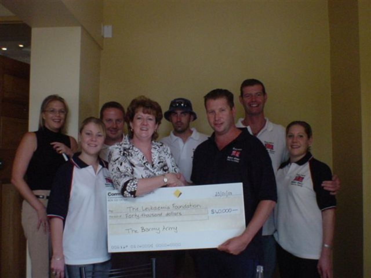 Paul 'leafy' Burnham and members of the Barmy Army present a cheque for USD40 000 to the Leukaemia Foundation, raised during the Ashes tour 2002-2003.