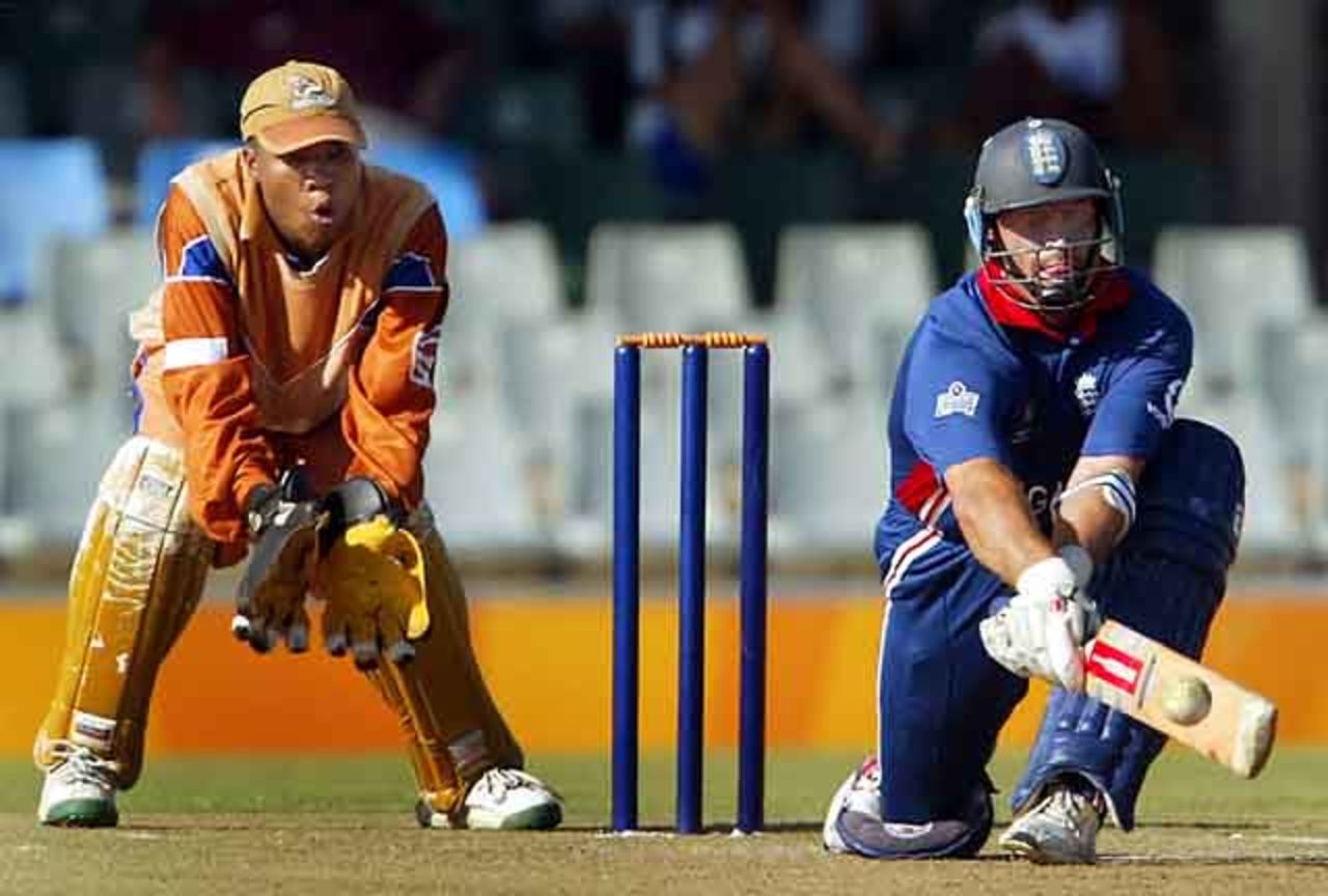 England's skipper Nasser Hussain reverse sweeps as Border Bears' wicket keeper Abongile Sodumo, World Cup warm up match at Buffalo Park in East London, South Africa, February 6, 2003.