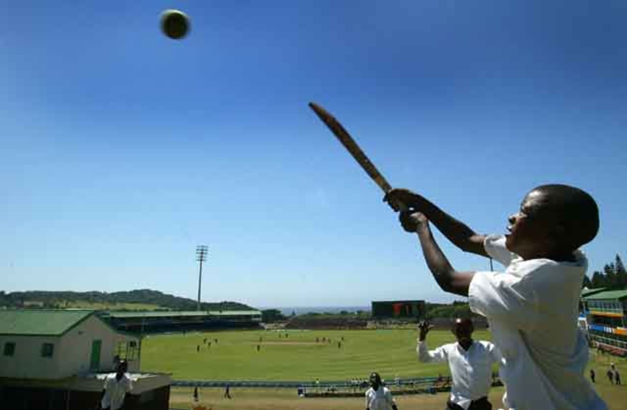 Youngsters play cricket as England play Border Bears, World Cup warm up match at Buffalo Park in East London, South Africa, February 6, 2003.