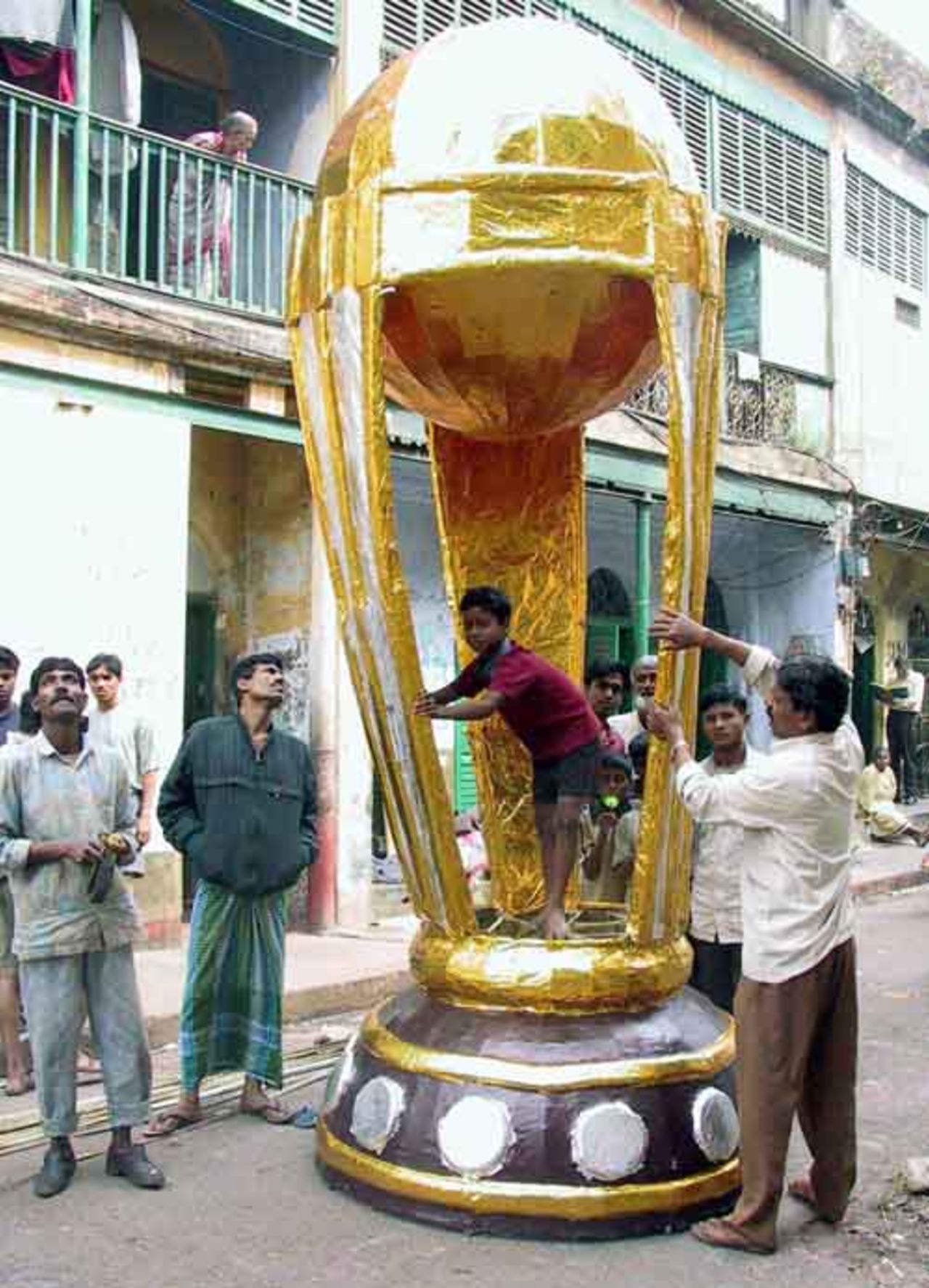 An Indian artist gives finishing touches to a giant model of the cricket world cup trophy in Calcutta February 5, 2003.