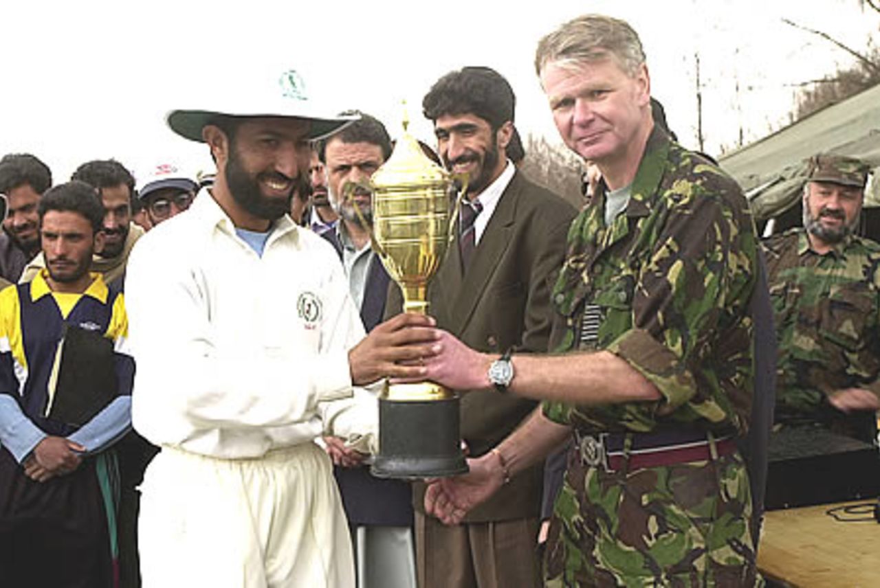 ACF Captain receiving the winners trophy while ACF president Allah Dad Noori looks on, ACF v ISAF (International Security Assistance Force) one-day tournament at Kabul. Three one-dayers were played and ACF won all three matches