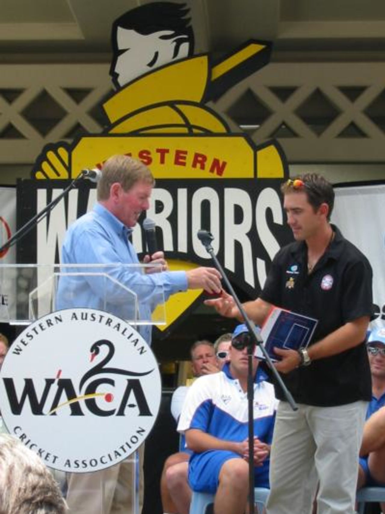 Justin Langer holding his $5000 ING Investment Trust Account, is handed a pair of  cufflinks shaped in the form of wickets and a bat valued at $3000 from ING Sponsorship Manager Geoff Prenter for being the Man of the 2002-03 ING Cup series at Forrest Place in Perth