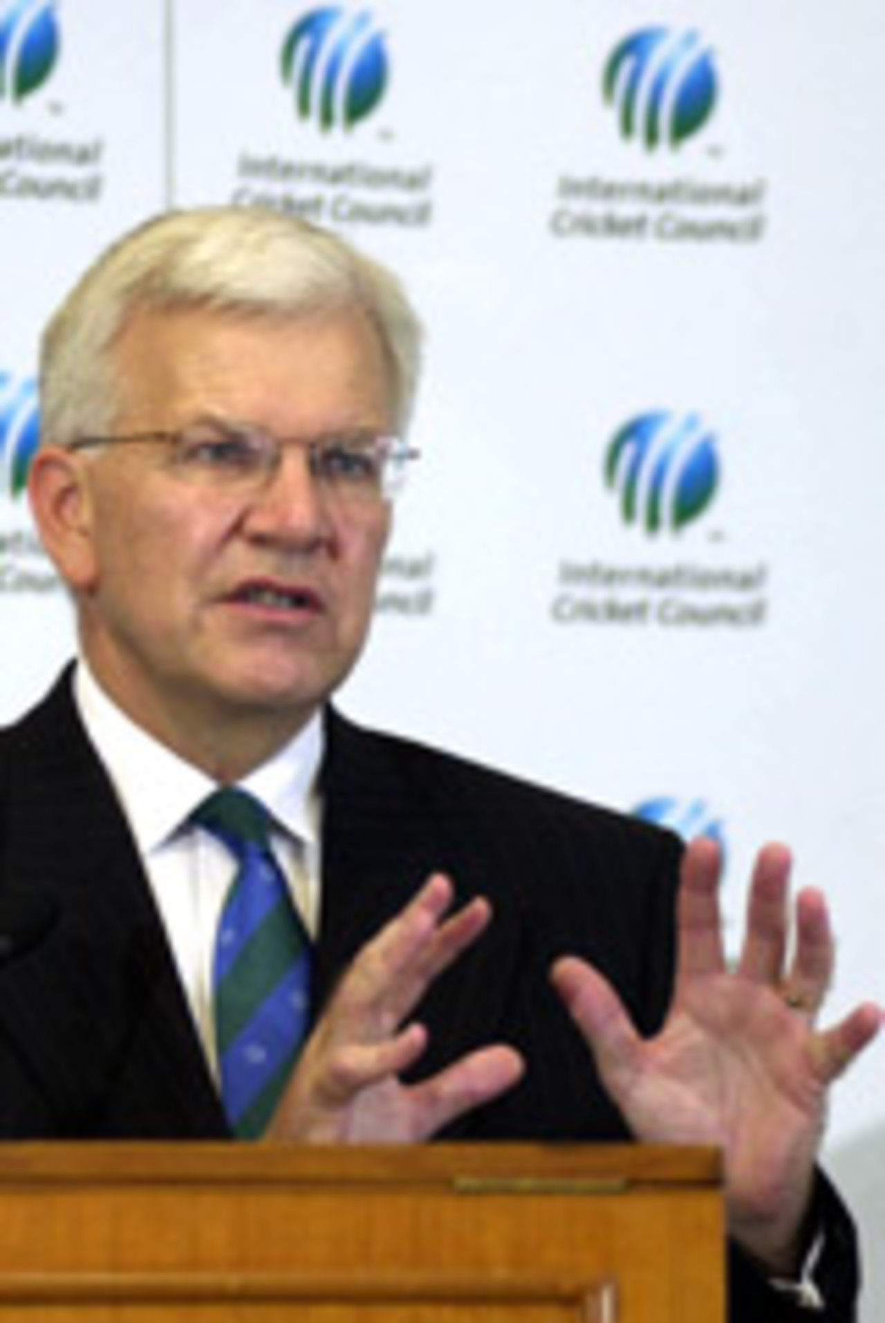 Malcolm Speed gestures at a news conference
