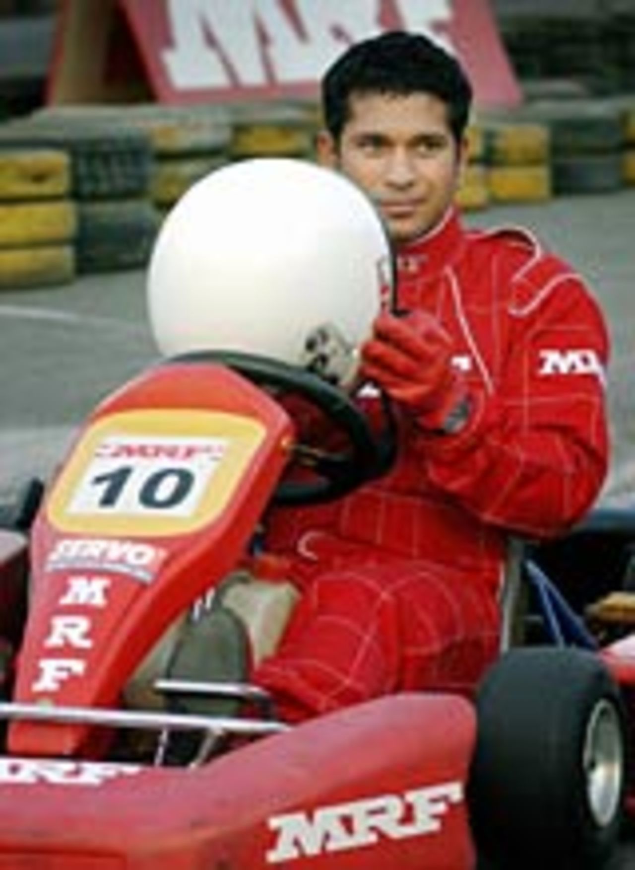 Indian cricketer Sachin Tendulkar poses for photographers at a go-kart track in Mumbai, February 22, 2004
