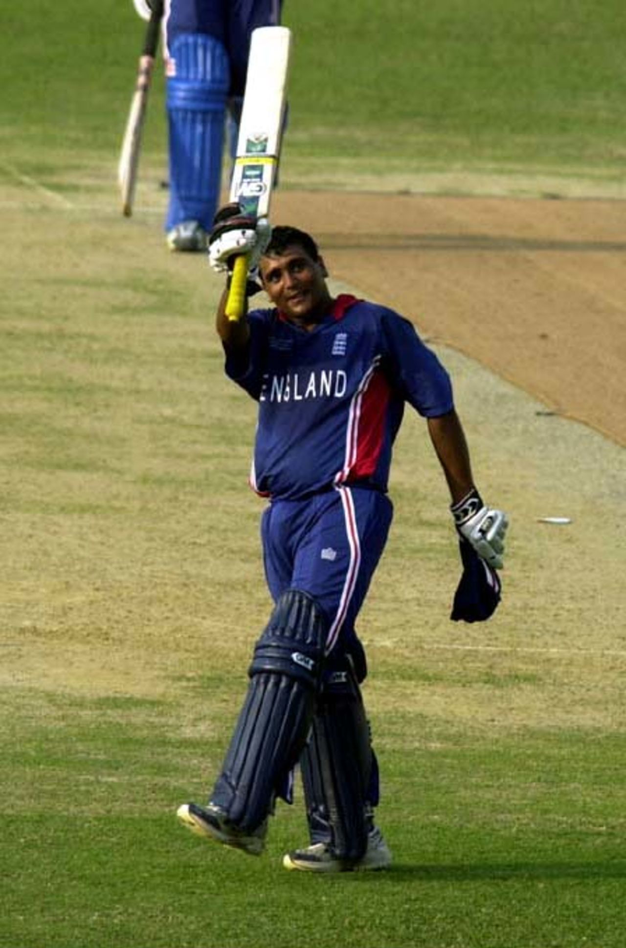 England Batsman S Patel lifts his bat after his century, 23 February 2004 at Dhaka