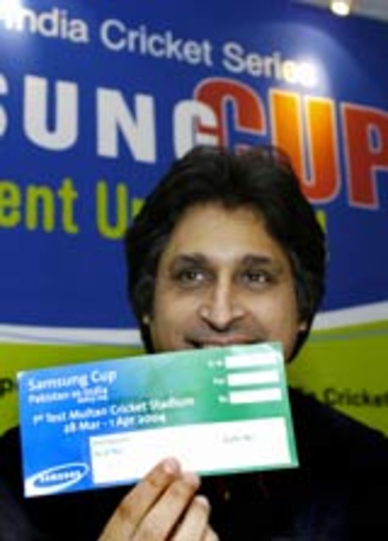 Pakistan board chairman Rameez Raja shows a specimen of a ticket for the series between Pakistan and India, Fenbruary 27, 2004