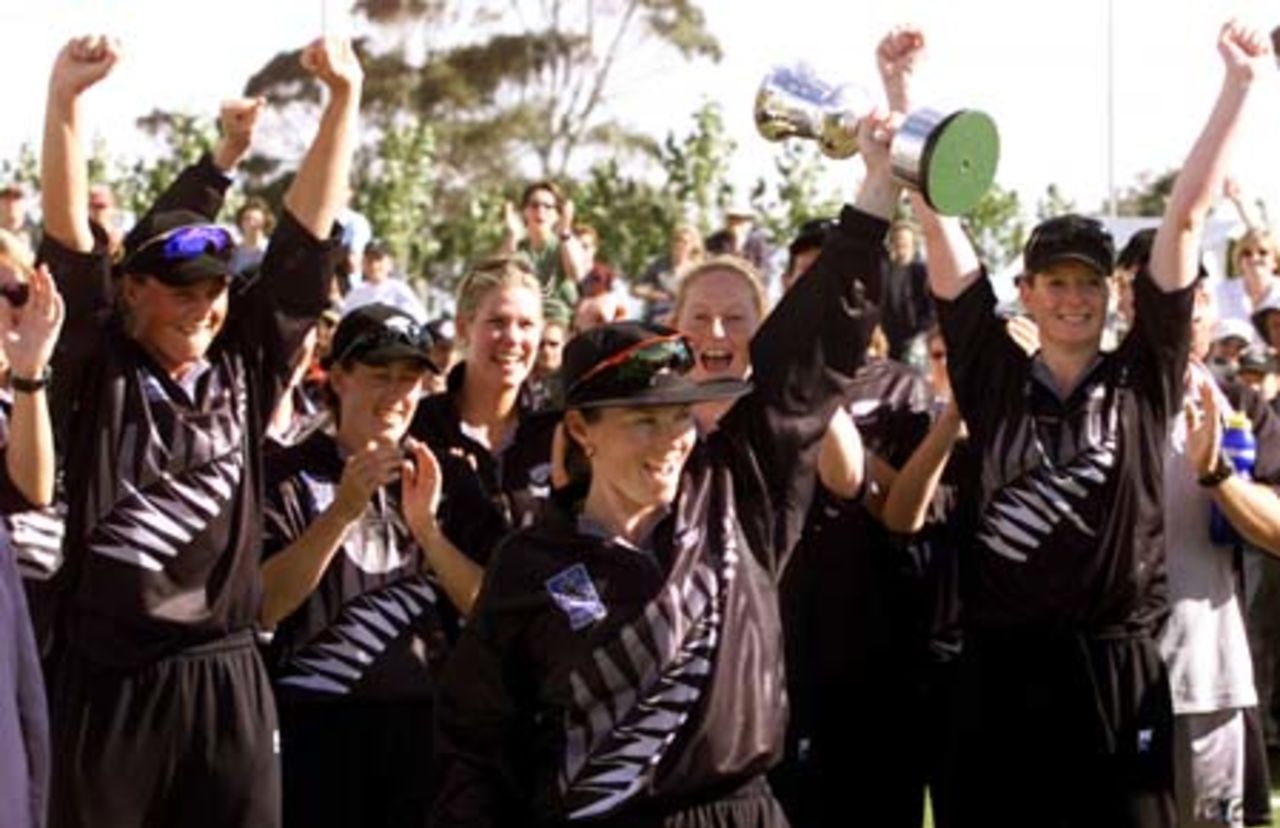 New Zealand captain Emily Drumm holds the World Cup aloft as her team mates celebrate after the New Zealand v Australia match in the Final of the 2000 CricInfo Womens Cricket World Cup played at BIL Oval, Lincoln, New Zealand