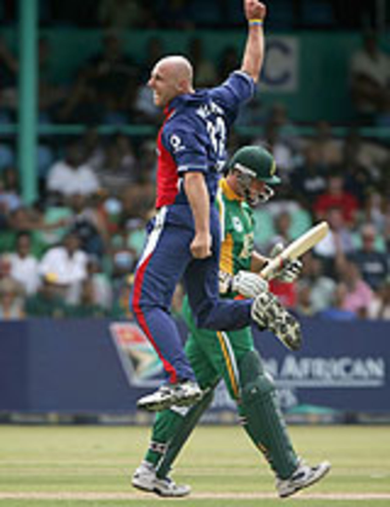 Alex Wharf leaps in triumph as Graeme Smith falls early, in the sixth one-day international at Durban, South Africa v England, February 11, 2005