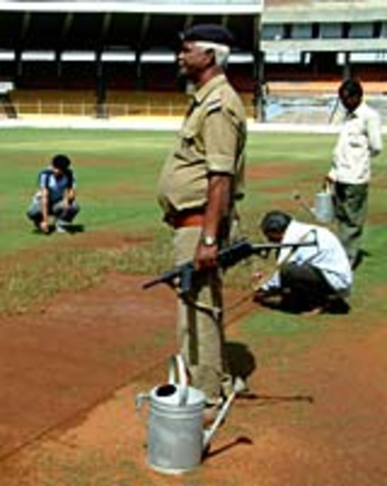 Indian workers prepare the main pitch at the Motera Stadium, Ahmedabad, February 18, 2005
