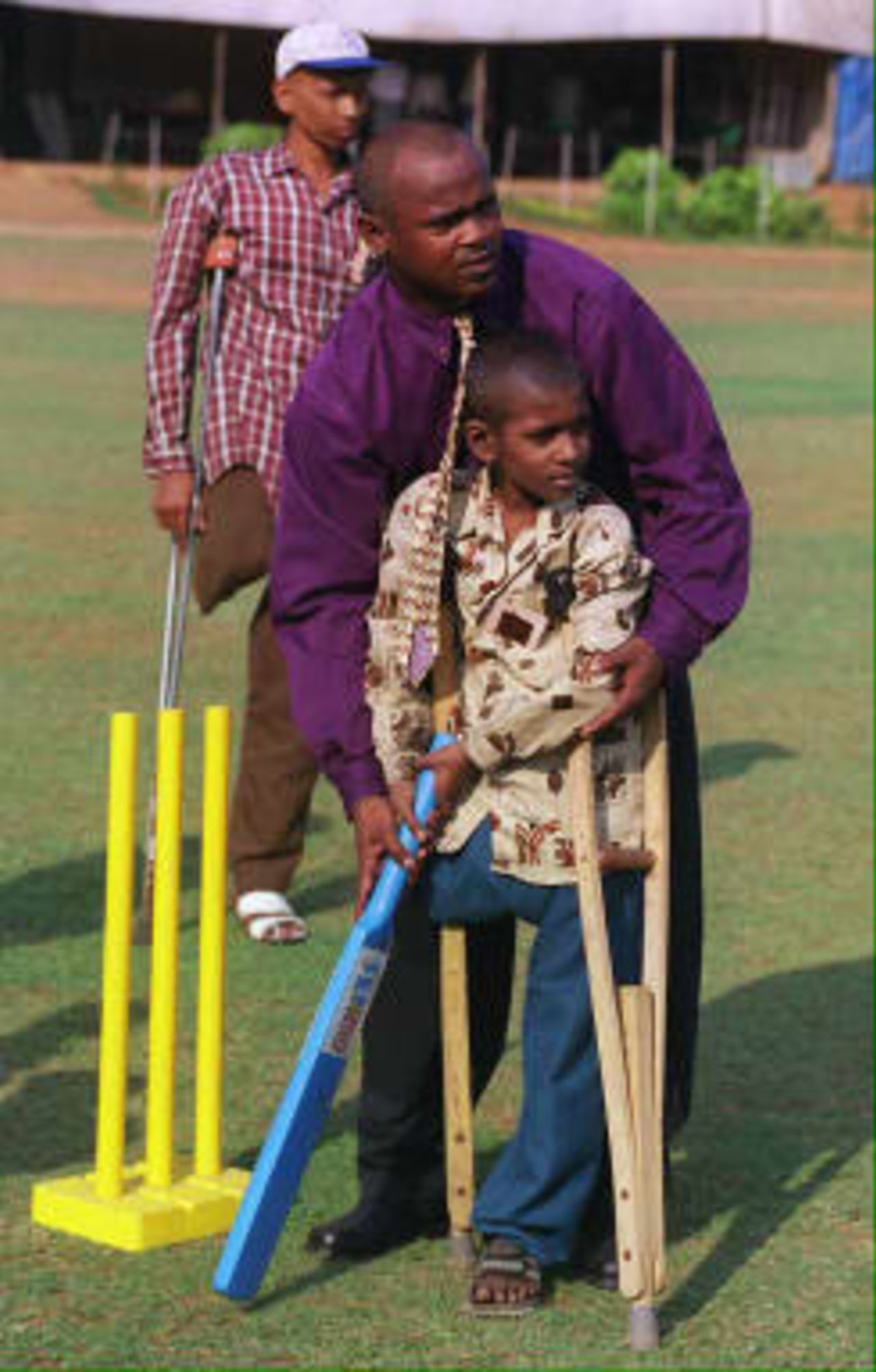 Eight-year old cancer victim Durganand Paswan gets a lesson from  Kambli - 05 March 1999. Fifty children under treatment for cancer met and mixed with sports personalities organised by V Care Foundation.