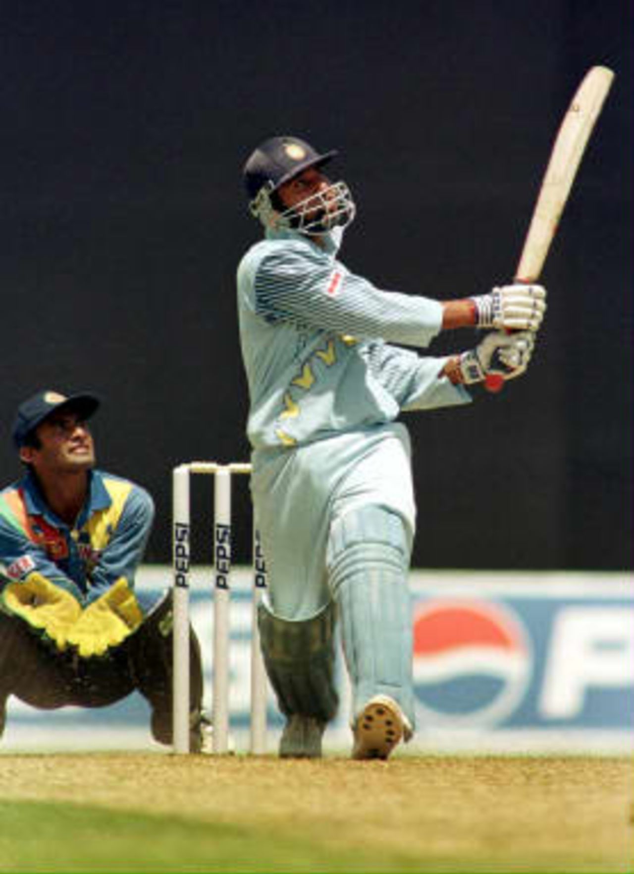 Indian captain Ajay Jadeja hits a six as Sri Lankan wicketkeeper Hashan Tillekaratne looks on, on 30 March 1999, at Nehru Stadium in Pune.