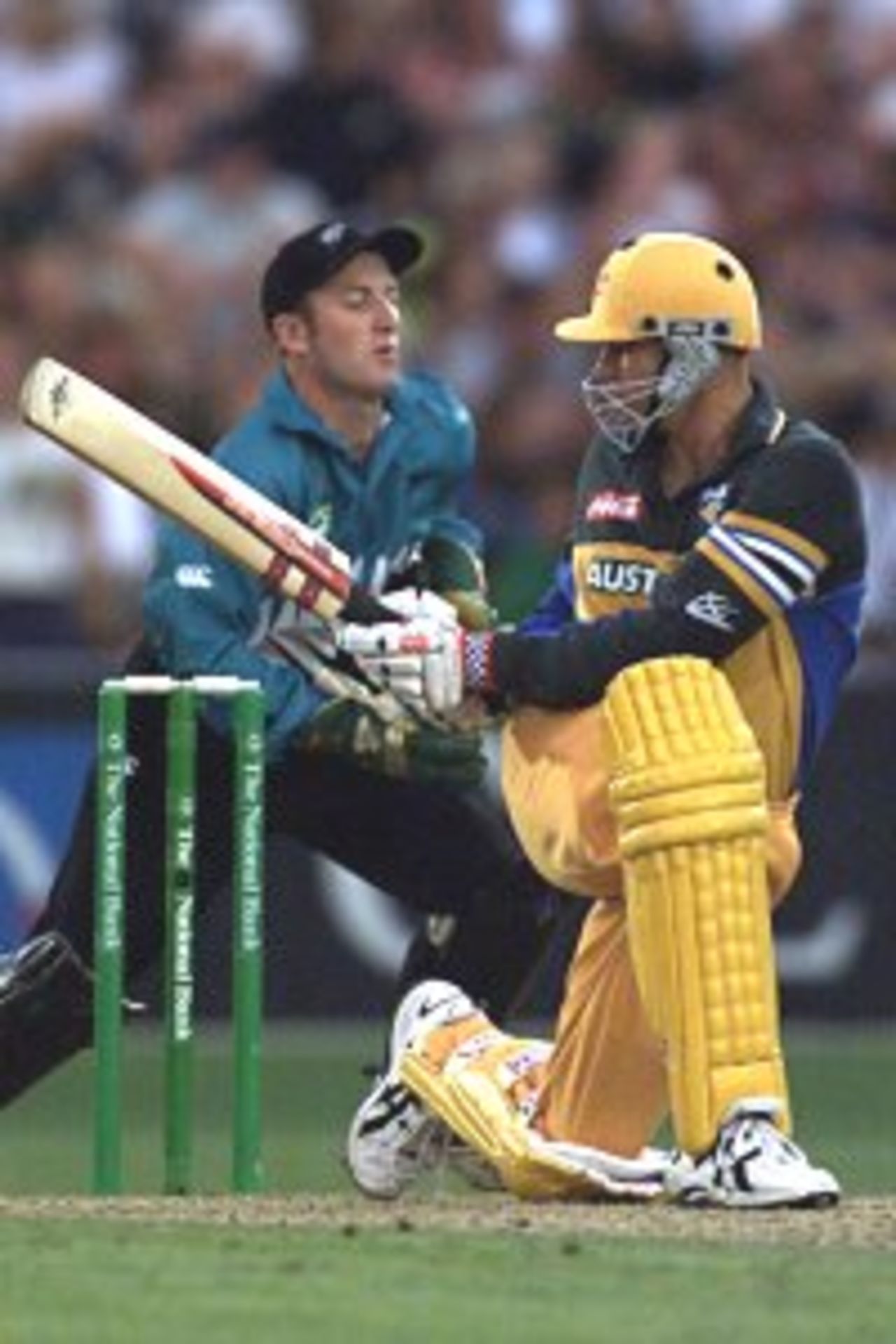 01 Mar 2000: Matthew Hayden of Australia sweeps, with Chris Nevin of New Zealand looking on, during the fifth one day international between New Zealand at McLean Park, Napier, New Zealand.