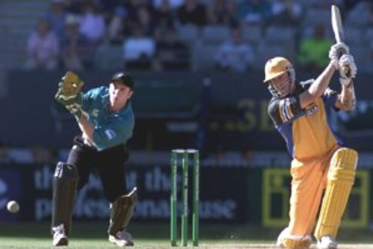 03 Mar 2000: Glenn McGrath of Australia hits out on his way to personal best 11 runs with Chris Nevin of New Zealand looking on, during the sixth one day match between New Zealand and Australia at Eden Park, Auckland, New Zealand.