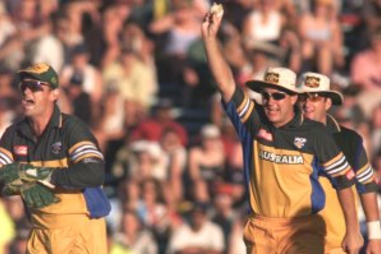 03 Mar 2000: Shane Lee (centre) of Australia celebrates alongside Adam Gilchrist (left) and Mark Waugh (right) after catching Matthew Sinclair of New Zealand off the bowling of Shane Warne, during the sixth one day match between New Zealand and Australia at Eden Park, Auckland, New Zealand.