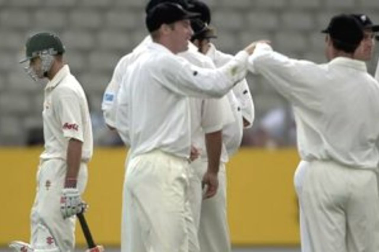 11 Mar 2000: Australian batsman Greg Blewitt walks past celebrating New Zealand fieldsmen after being dismissed for 17 runs during day 1 of the first test between Australia and New Zealand at Eden Park,Auckland, New Zealand.