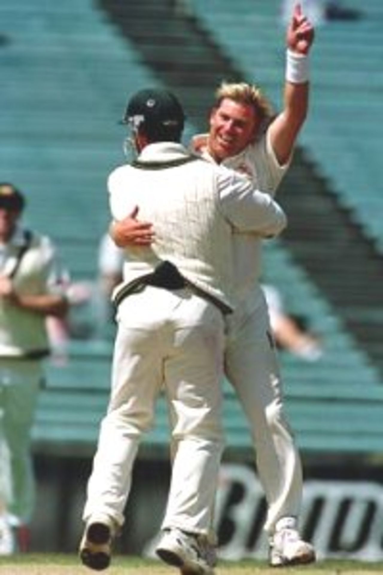 15 Mar 2000: Australian spin bowler Shane Warne is congratulated by Justin Langer as he takes the wicket to break Dennis Lillee's record to give him 356 Test wickets on day five of the first test match between New Zealand and Australia, Eden Park, Auckland, New Zealand.New Zealand batsman Paul Wiseman was out caught behind by Adam Gilchrist. The wicket also won the match for Australia.