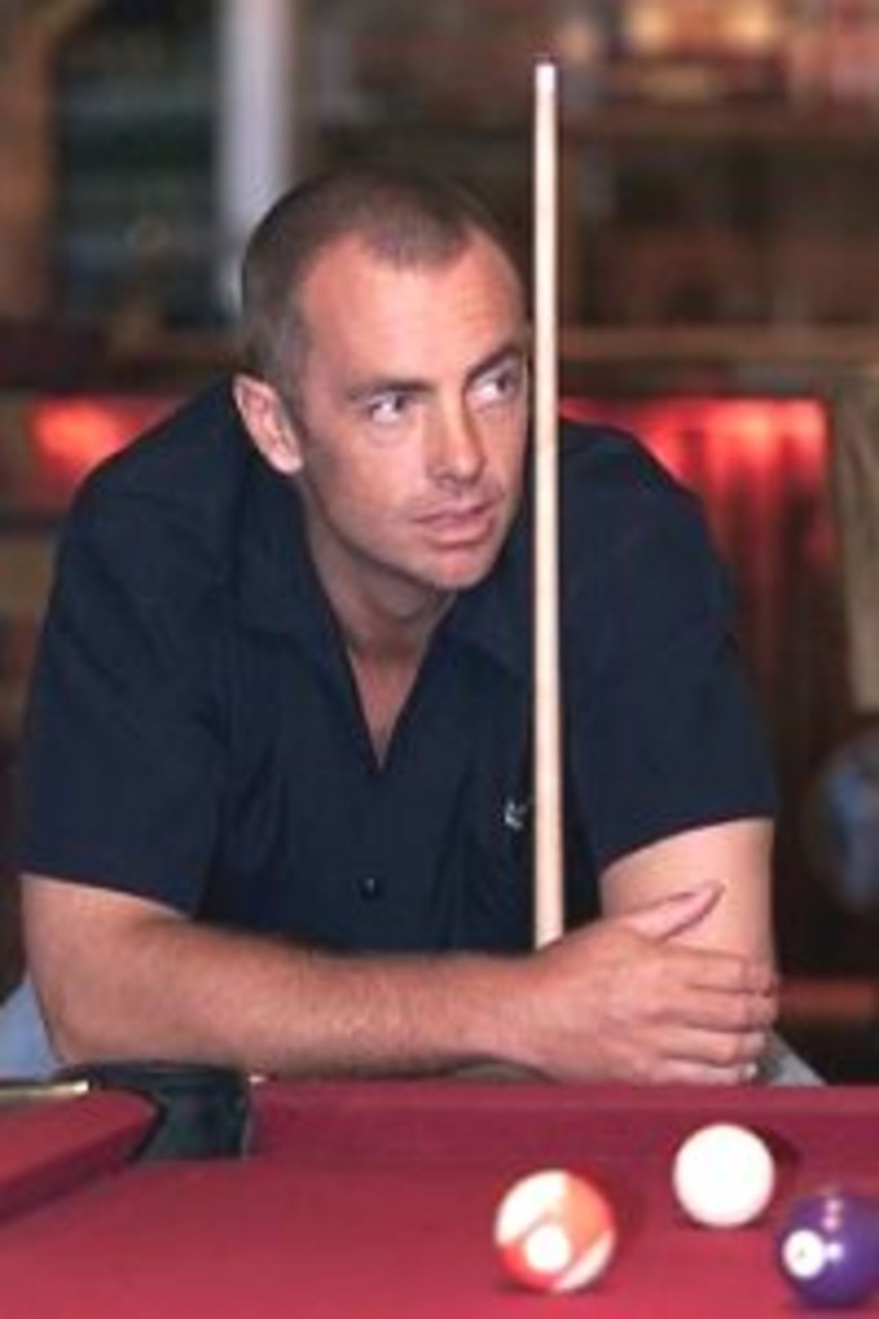 17 Mar 2000: Colin Miller of Australia relaxes at the pool table in the Grumpy Mole Saloon, Napier, New Zealand.