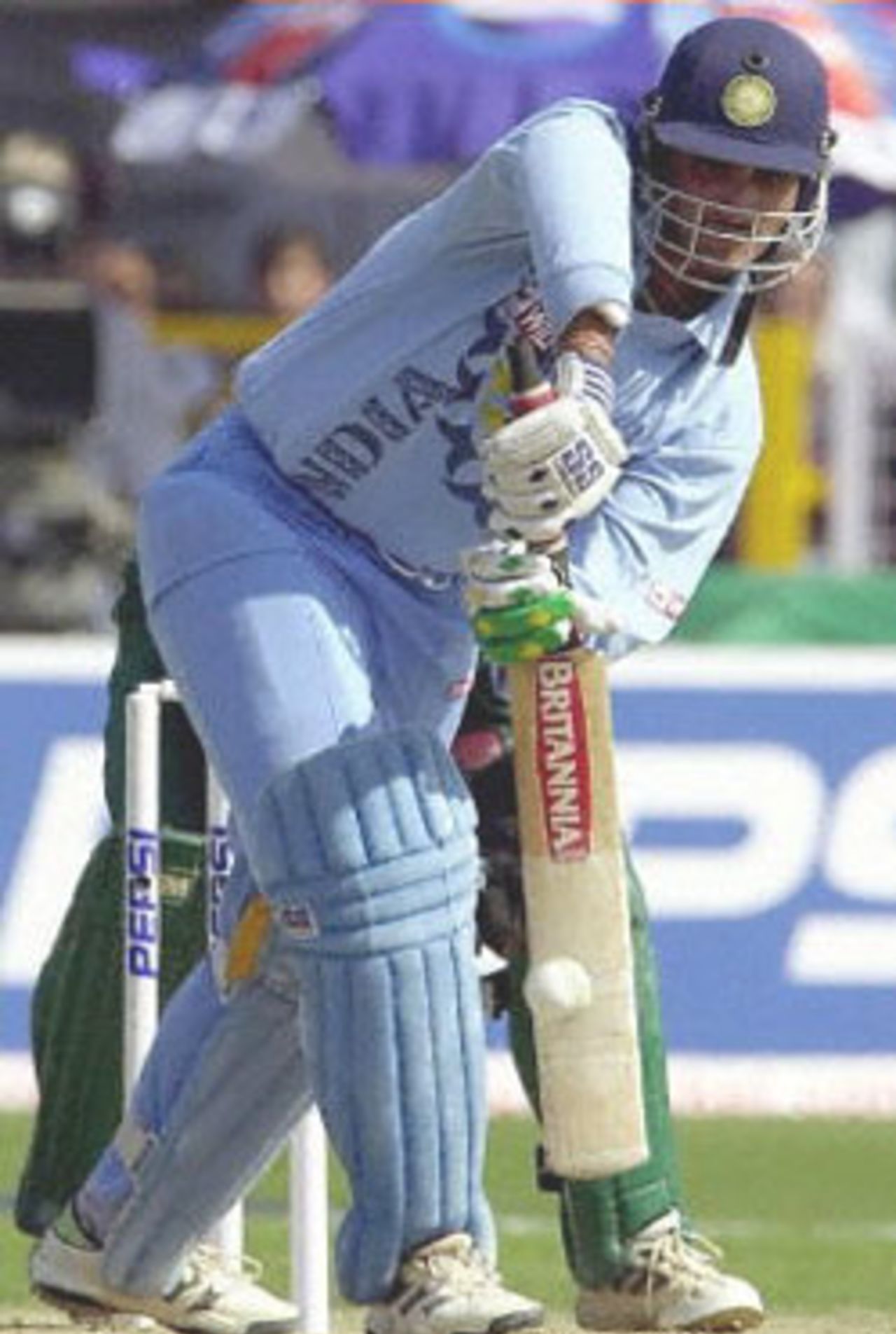 Indian captain and opening batsman Saurav Ganguly, blocks a delivery on his way to scoring a quick 56 runs during the one-day cricket international between India and South Africa, 15 March 2000 in Faridabad. South Africa are chasing India's challenging 248. In the background is South African wicket keeper Mark Boucher.