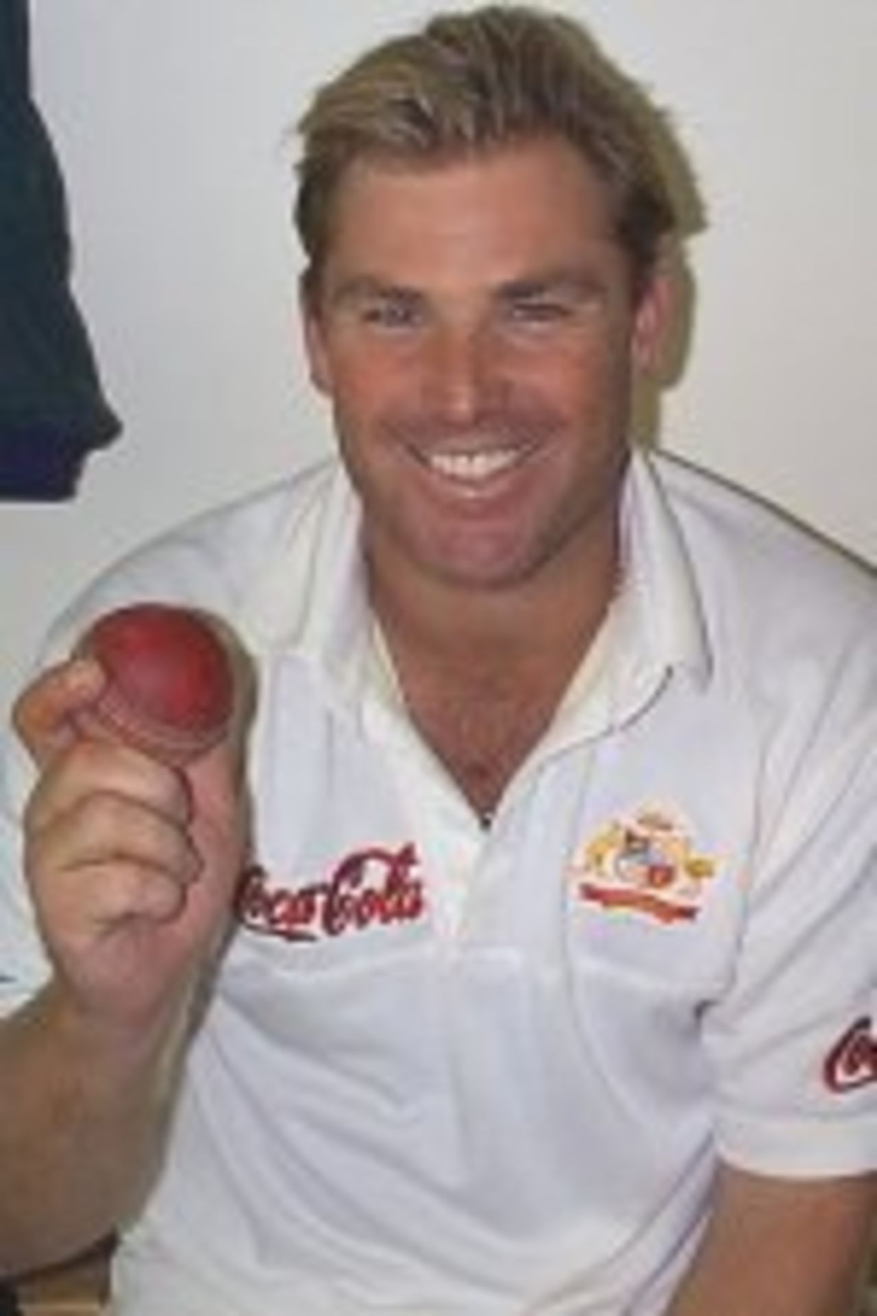 Shane Warne smiles as he holds up the ball that took the record breaking 356th Test wicket in New Zealand, March 2000
