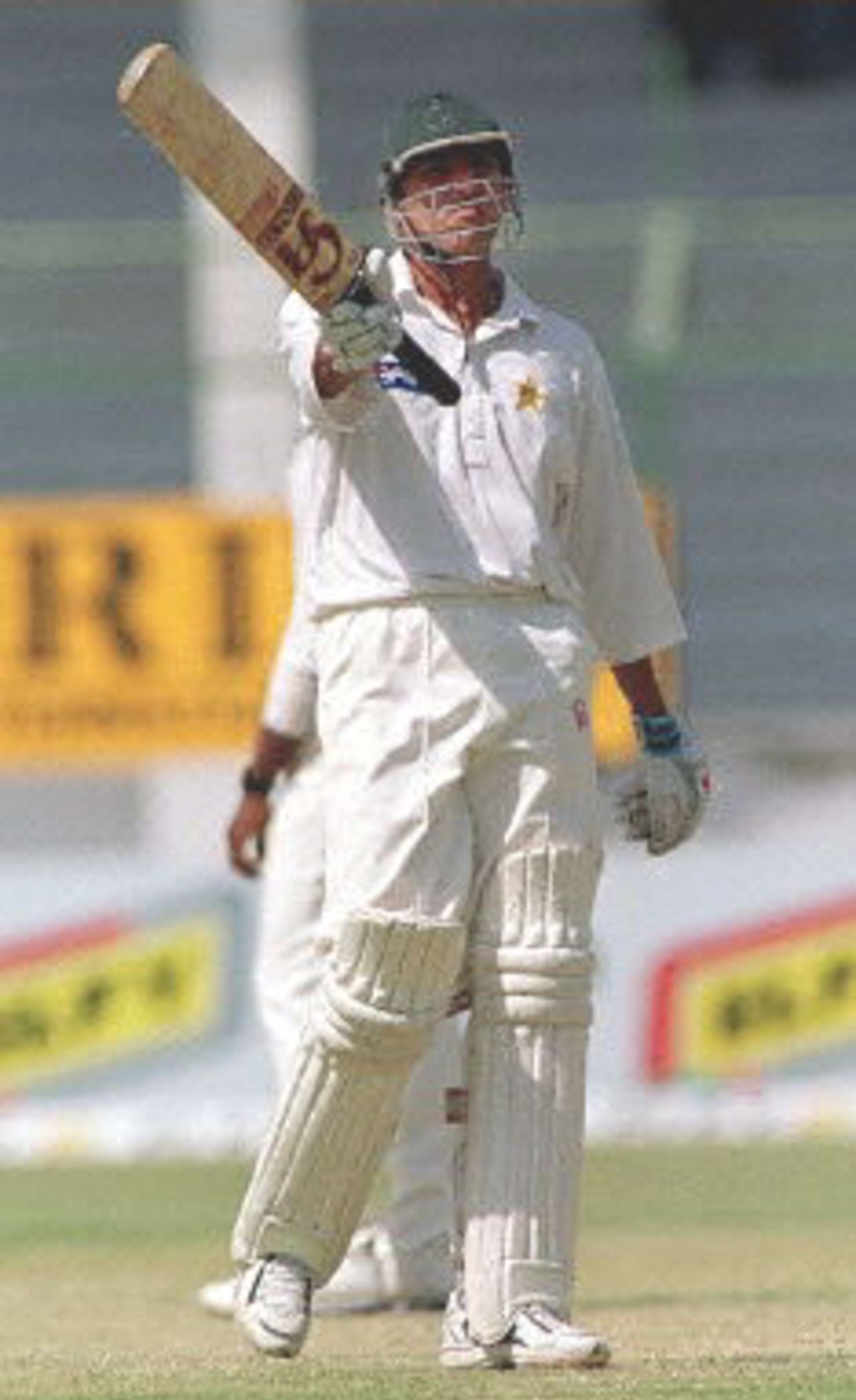 Pakistani middle order batsman Younis Khan waves his bat in jubilation as he reached fifty on the third day of the third and last cricket Test in Karachi, 14 March 2000. Khan, who scored a debut century in his first Test against Sri Lanka, made 61 runs in Pakistan's second inning. At stumps Pakistan were 375-7 having overall lead of 404.