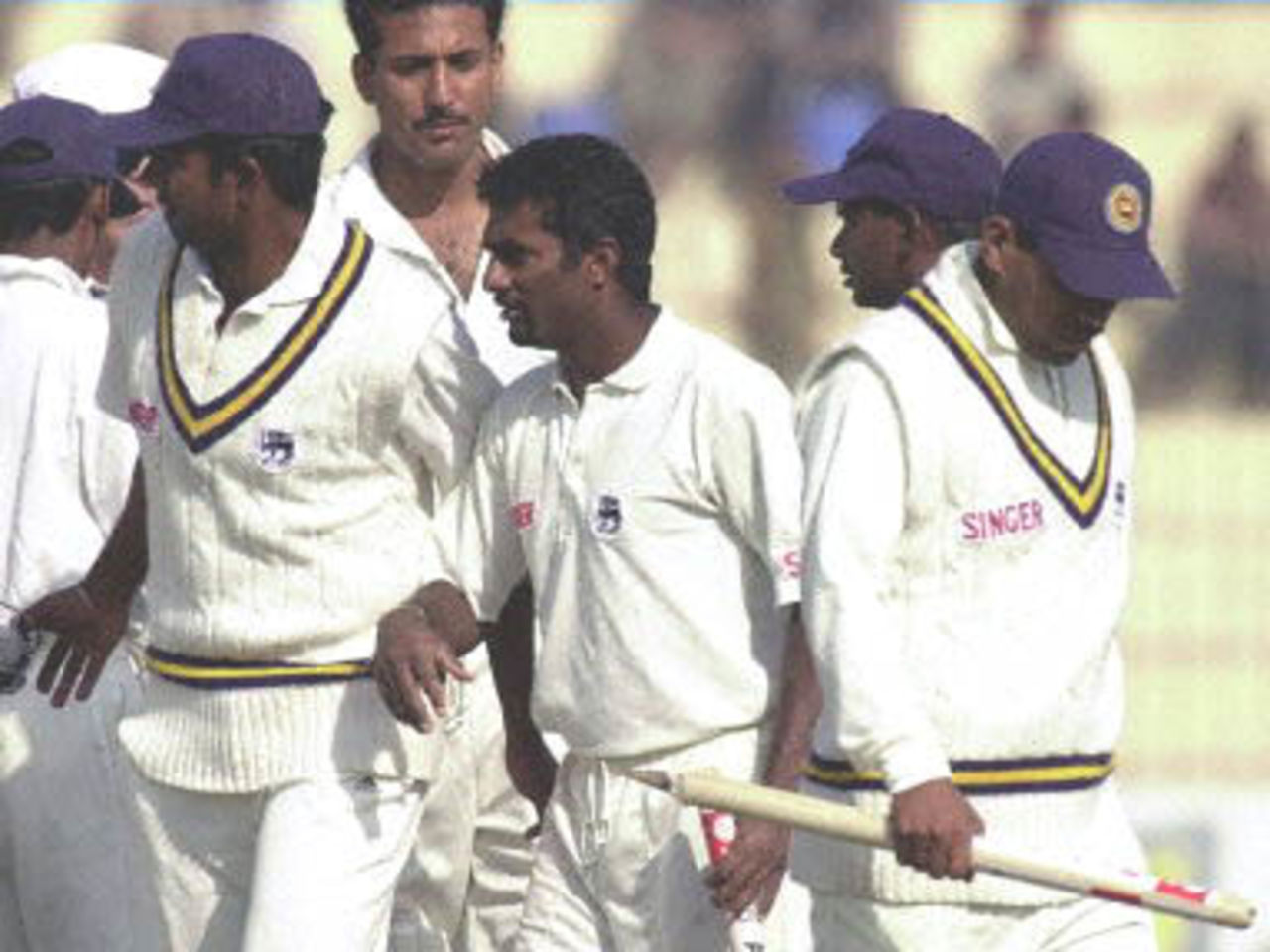 Sri Lankan off-spinner Muttiah Muralitharan (C) leaves the ground with other teammates after winning the 2nd Cricket Test against Pakistan in Peshawar, 09 March 2000. Muralitharan took 6-71 while collected ten wickets in the match and was declared Man of the Match. Sri Lanka defeated Pakistan by 57 runs and won the three Test series by 2-0.