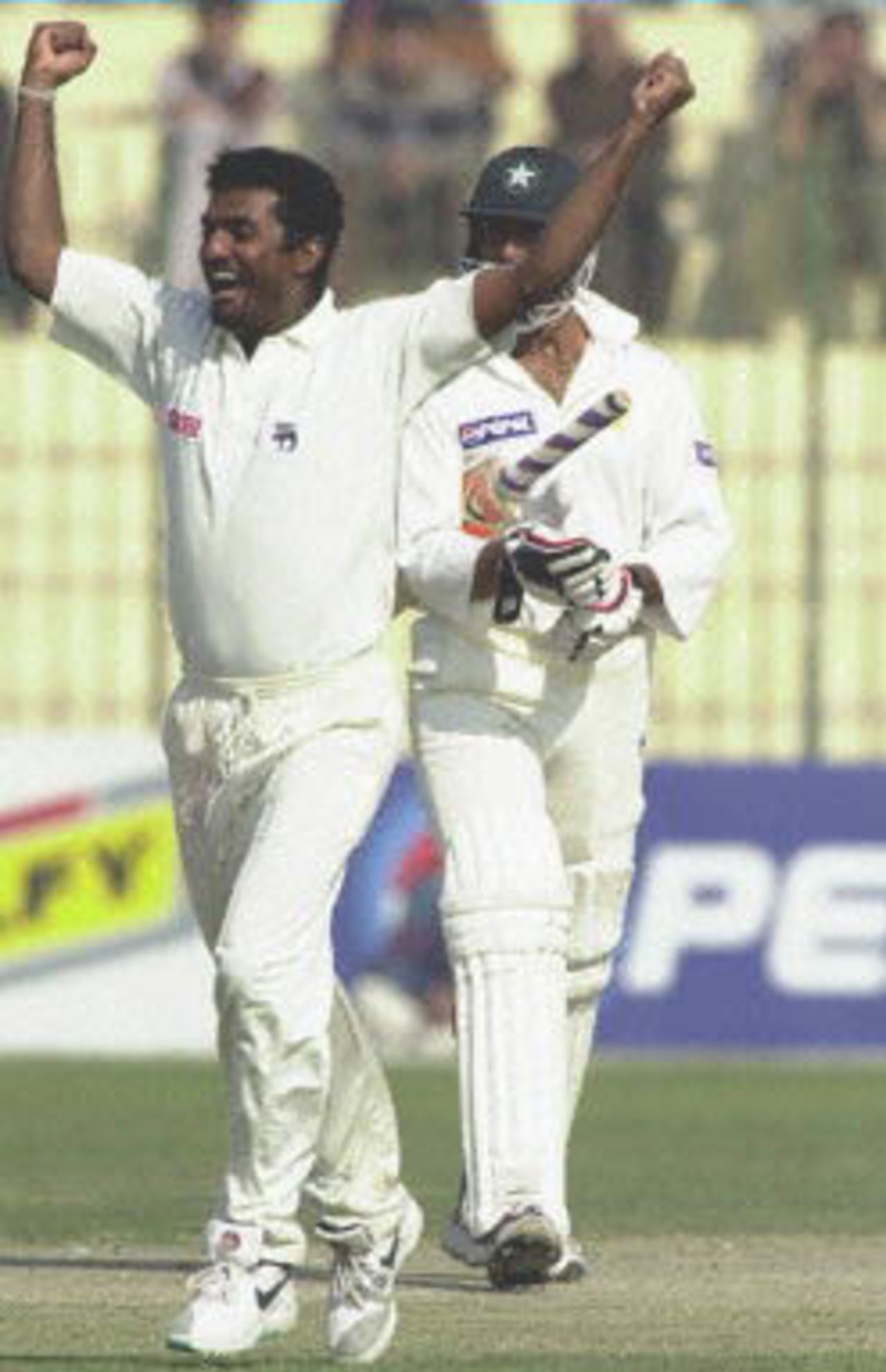 Sri Lankan off-spinner Muttiah Muralitharan (L) celebrates the fall of last the Pakistan batsman's wicket on the last day of play of the 2nd cricket Test match in Peshawar, Pakistan 09 March 2000. Muralitharan took 6-71 while collecting ten wickets in the match and was declared Man of the Match. Sri Lanka defeated Pakistan by 57 runs and won the three Test series 2-0.